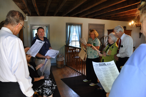 A photo of people each looking at a piece of paper.