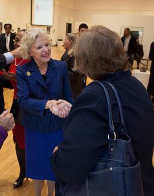 Supreme Court Justice Anne Burke shakes a woman's hand