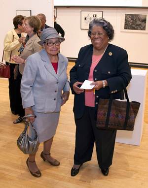 A photo of two women attending the performance at the Hatheway Cultural Center