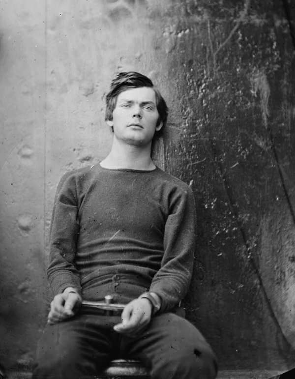 A portrait of Lewis Powell (Payne) sitting while handcuffed.